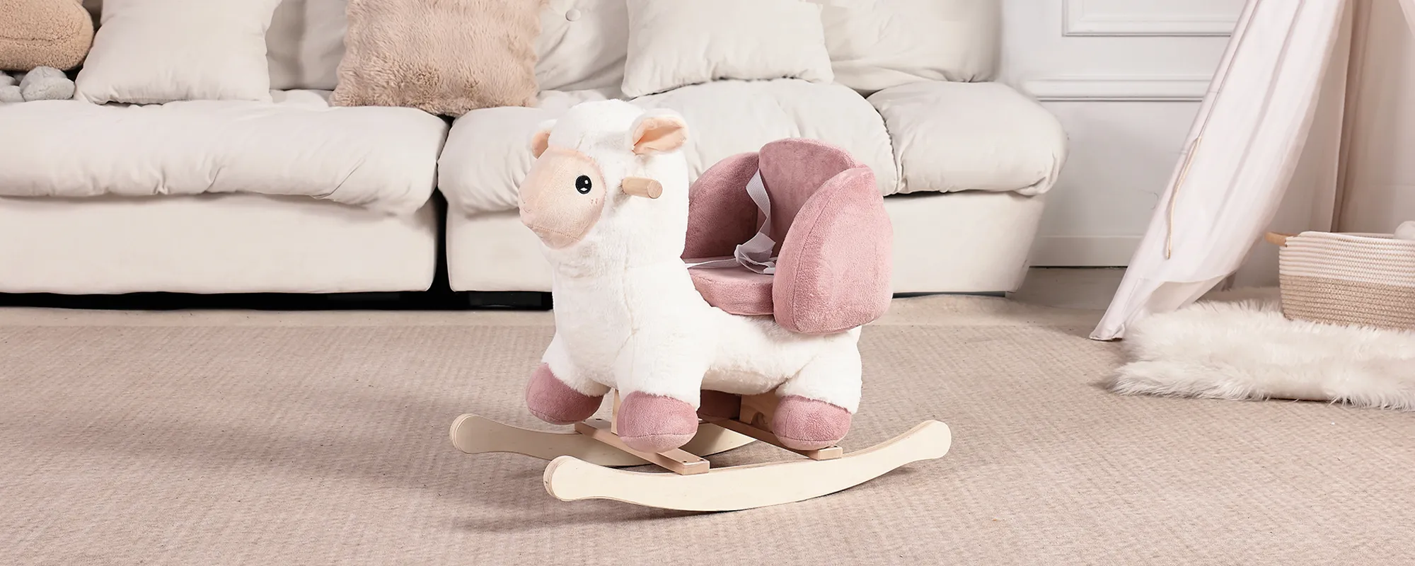 White and pink sheep plush rocking chair styled in cozy living room with teepee tent
